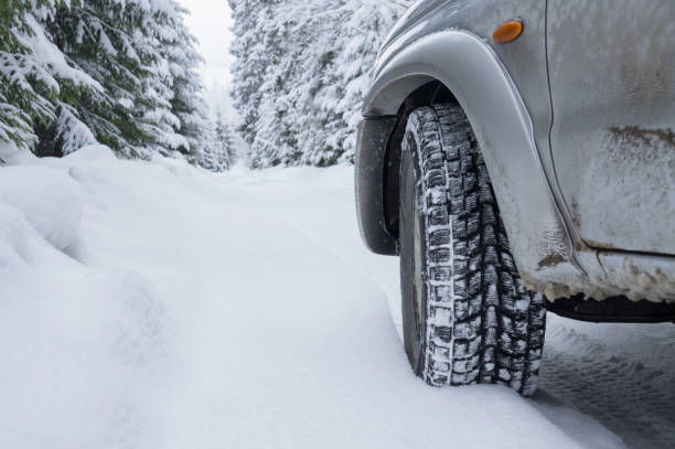 istock Winter Tire on Snow covered road 1191499158