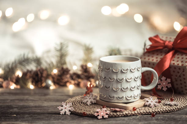 istock Festive background with Cup on wooden background with lights. 1191501534