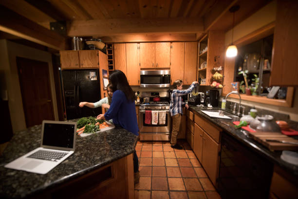 istock Children play and help while mom prepares and cooks dinner 1191503163