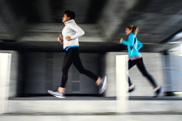istock Two Female Athletes Running Outdoors, Blurred Motion 1191505821