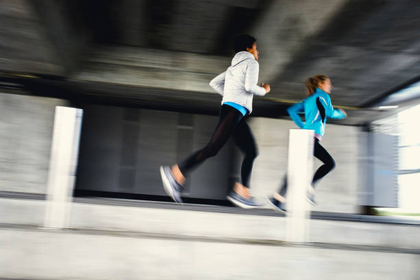 istock Two Female Athletes Running Outdoors, Blurred Motion 1191505958