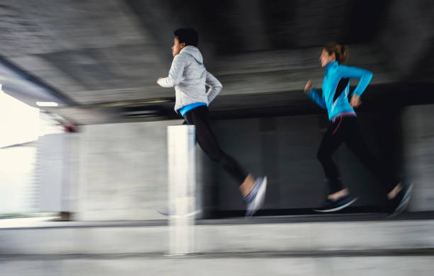 istock Two Female Athletes Running Outdoors, Blurred Motion 1191506053