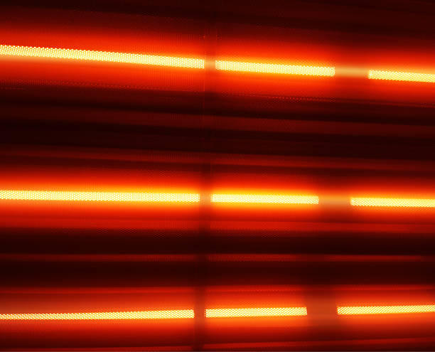 istock Neon orange lamps in metal perforated case background 1191506146