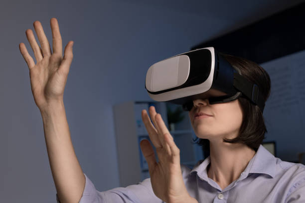 istock Contemporary employee with vr headset standing in front of virtual display 1191506149