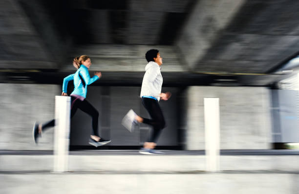 istock Two Female Athletes Running Outdoors, Blurred Motion 1191506254