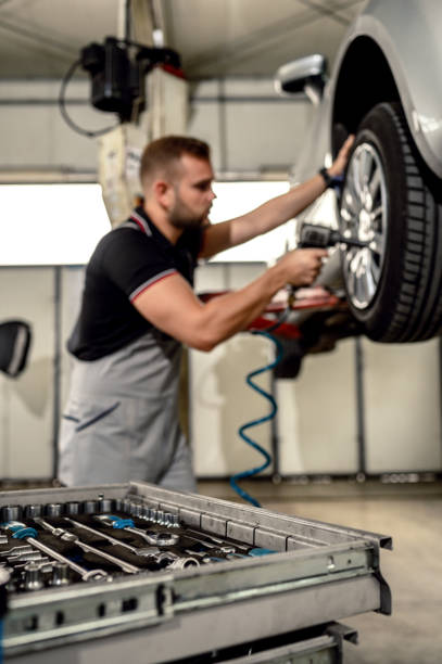istock Car mechanic is changing tire 1191506443