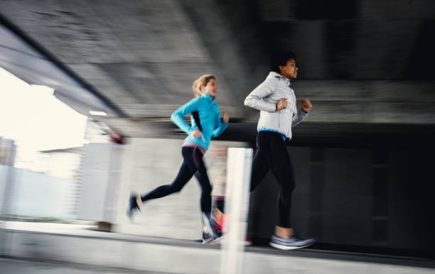 istock Two Female Athletes Running Outdoors, Blurred Motion 1191506508