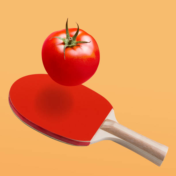 istock red ping-pong racket as if striking a red fresh tomato, tomato flies, concept 1191507619