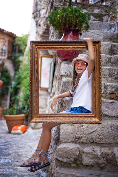 a teenage girl in the antique frame at the streets of eze, france - nice looking imagens e fotografias de stock