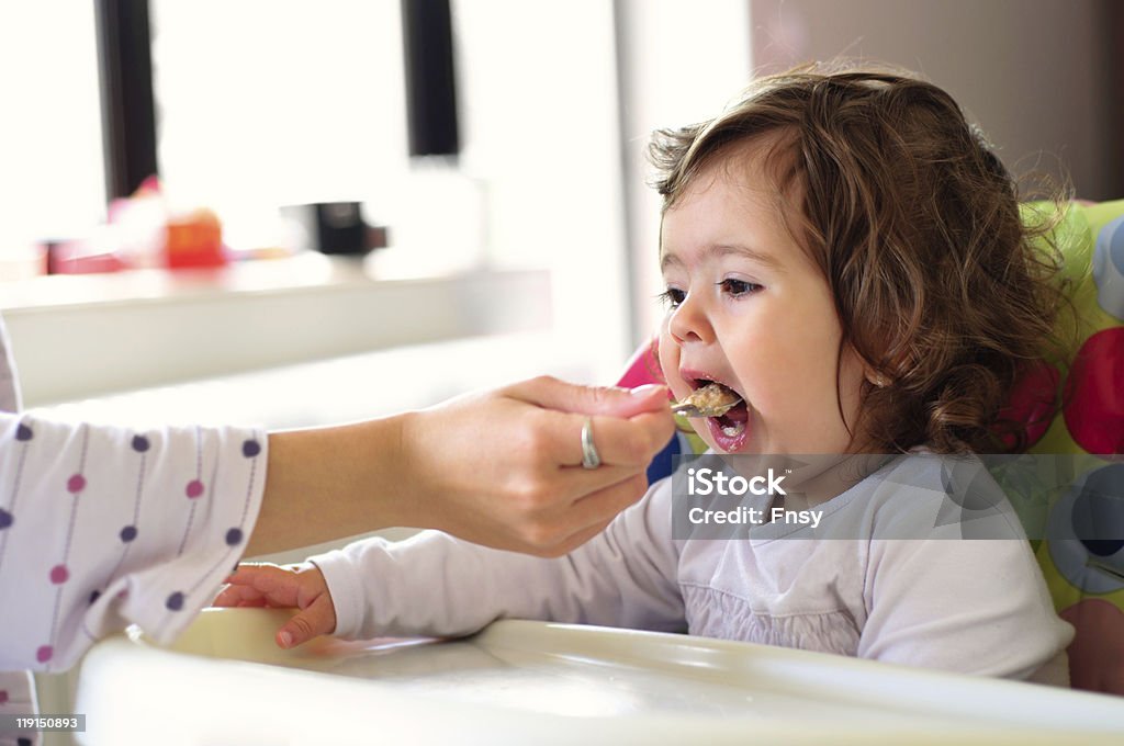 Mother feeding a baby  12-17 Months Stock Photo