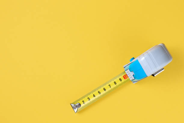 istock Measuring tape isolated over yellow bakground. Carpenter and Construct concept. 1191509153