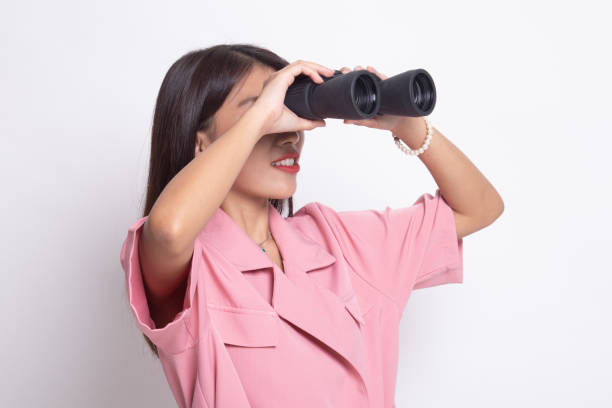 istock Young Asian woman with binoculars. 1191509240