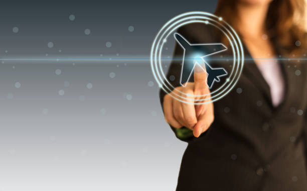 istock Businesswoman select a flight by touch screen airplane button 1191509578