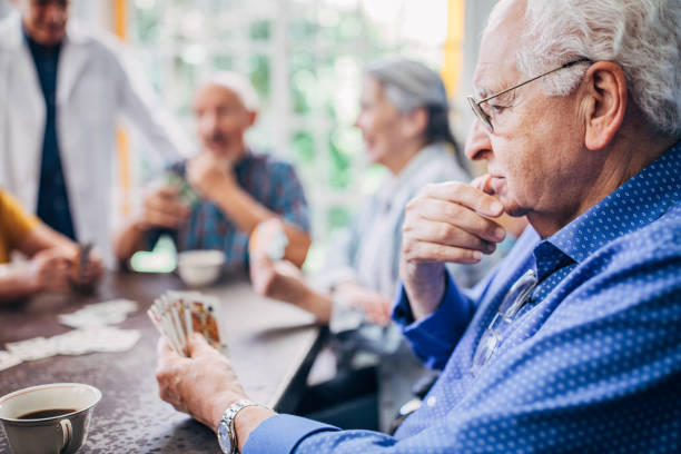 istock Group of seniors playing cards together 1191509947