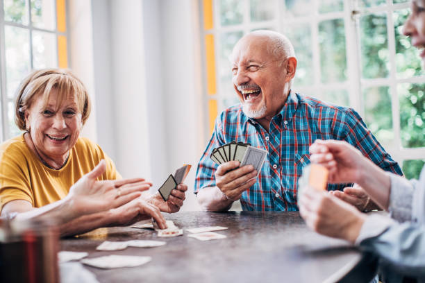 istock Group of seniors playing cards together 1191510017