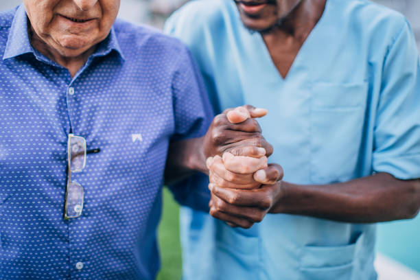 istock Nurse helping an elderly man at retirement home 1191510737