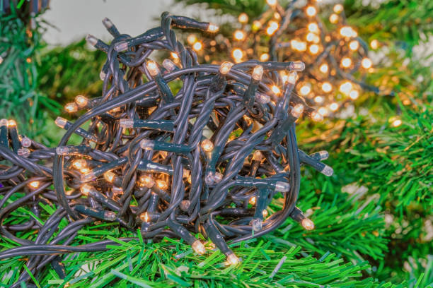 istock A series of low voltage string festive LED lights on a dark green cable with light effect & bokeh defocused warm lights background. 1191511162