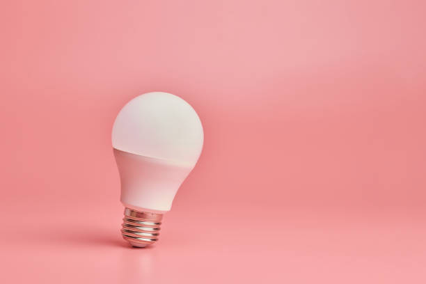 istock Light bulb, copy space. Energy saving minimal idea concept.Pink background. 1191512628