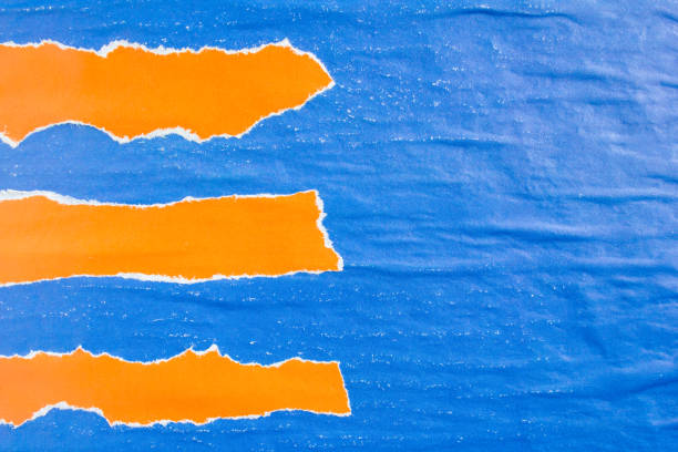 istock Blue and orange crumpled torn gloss shabby paper posters with rough surface texture background. Can be used for text. 1191512751