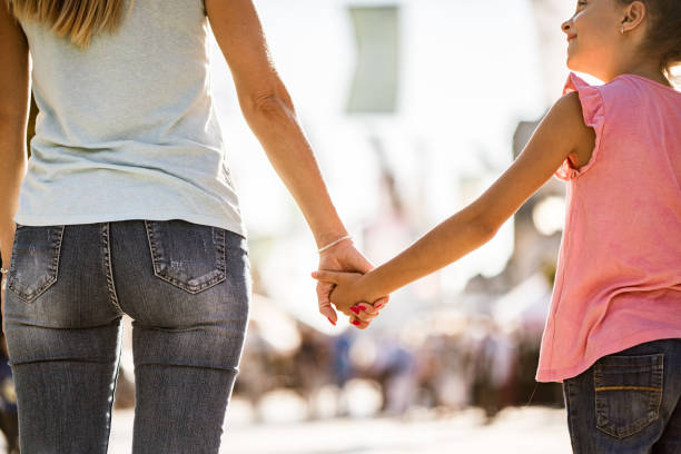 istock Back view young women holding hand a daughter 1191513222