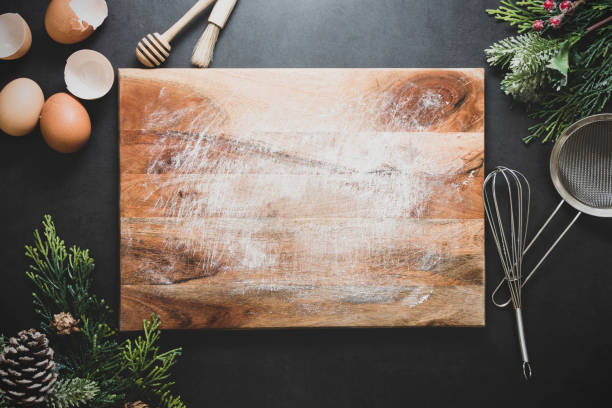 istock Christmas cooking or menu mock up. Empty cutting board and kitchen utensiles on dark background. Top view. Copy space. 1191514962
