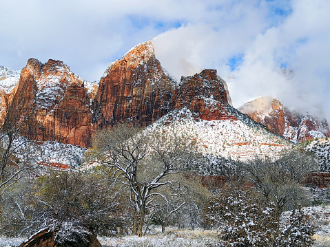 Peaks of Zion National Park as seen from the Pa'rus Trail as clouds clear from heavy snowstorm as seen near the Human Hiustory Museum and Springdale Utah