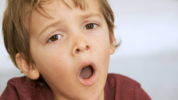 istock Serious little boy looking at the camera yawning 1191517180