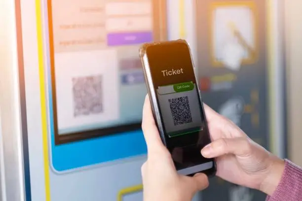 Photo of A girl scan QR code for buying the train ticket
