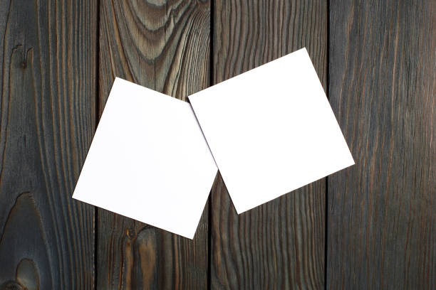 istock Two square blank cards on wood 1191517826