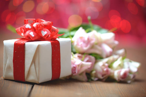 istock gift box on wood background and bokeh background 1191518647