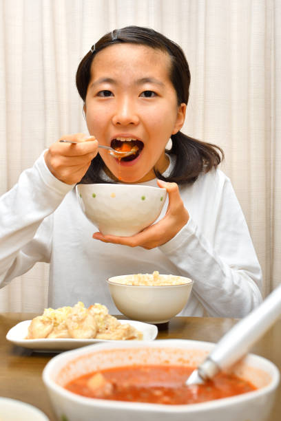 istock Japanese girl enjoys having dinner 1191519777