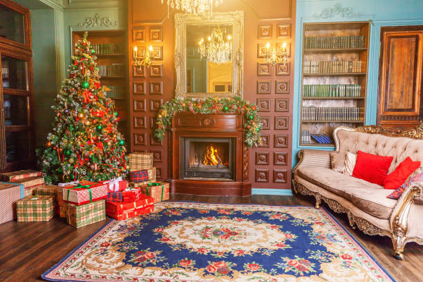 istock Classic Christmas New Year decorated interior room home library with fireplace. Christmas tree with red ornament decorations. Modern classical style interior design apartment. Christmas eve at home 1191520142