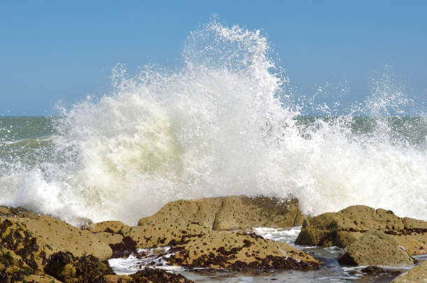 Waves crashing onto rocks. stock photo