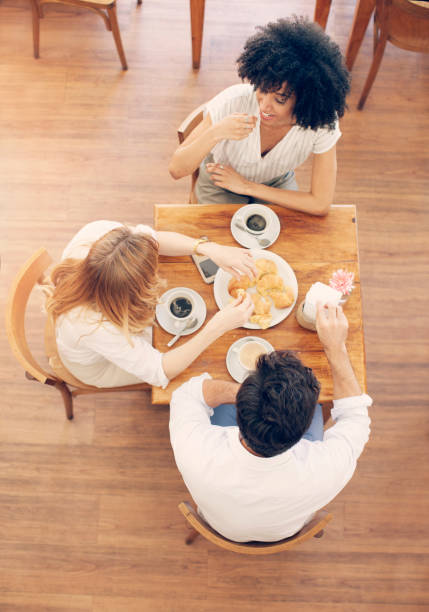 istock Group of friends talking and having fun at coffee store 1191523871