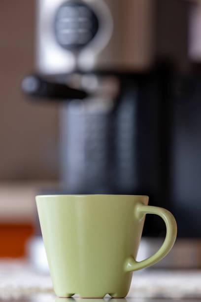 istock Coffee cup and coffee maker on the kitchen table. Morning coffee in the home kitchen. Light background. 1191524566
