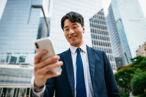 istock Korean businessman using smart phone and mobile app 1191525608