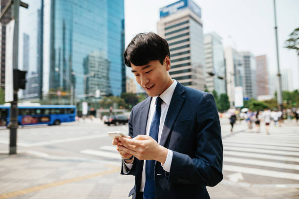 istock South Korean businessman using internet browser on smart phone 1191525696