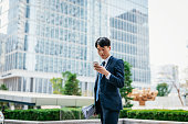 Korean financial manager using smart phone at work