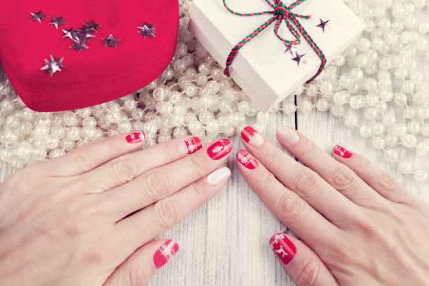 istock art christmas manicure, red and white color 1191525897