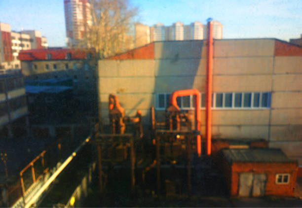 istock Industrial factory though dirty window background 1191528393