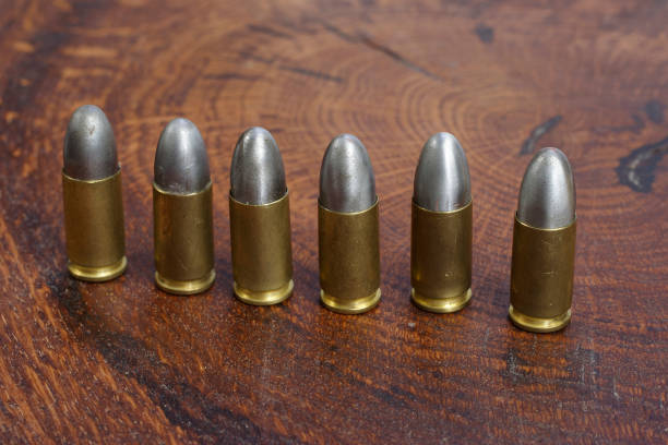 istock The 9mm caliber cartridges on wooden background 1191532006