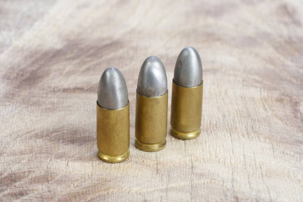 istock The 9mm caliber cartridges on wooden background 1191532030