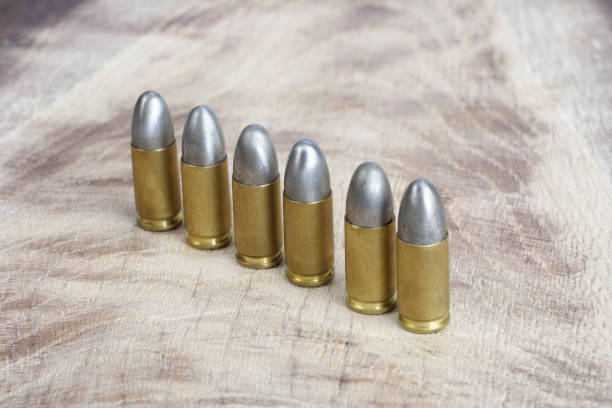 istock The 9mm caliber cartridges on wooden background 1191532132