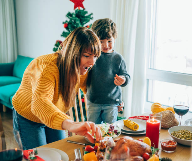 istock Happy mother and her son having fun while holding roasted turkey leg 1191532684