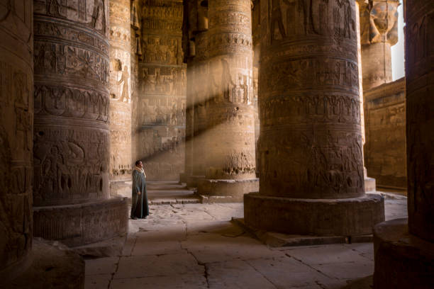 The guardian of the temple, Egypt Abydos, Egypt - November 07, 2018 :  
The guardian of the temple captured as he contemplates the rays of light that enters the temples through the openings of the walls. abydos stock pictures, royalty-free photos & images