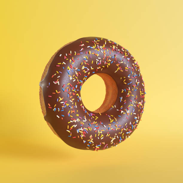 istock Chocolate doughnut on yellow background 1191534980