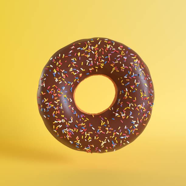 istock Chocolate doughnut on yellow background 1191535046