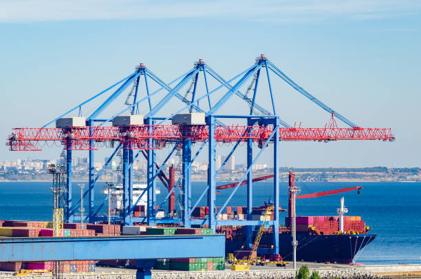 istock Port cargo crane loads a container onto a cargo ship 1191536391