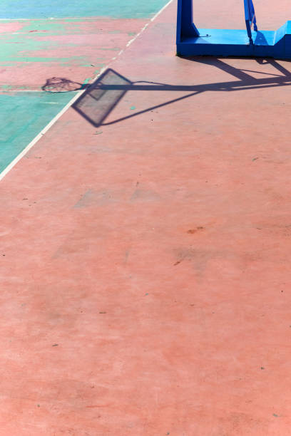istock basketball frame and its shadow in an outdoor court vertical composition 1191538105