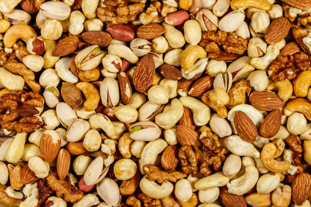 istock Background of mixed nuts (walnuts, pistachio, almond, peanut, cashew, hazelnut). Healthy eating concept 1191538220